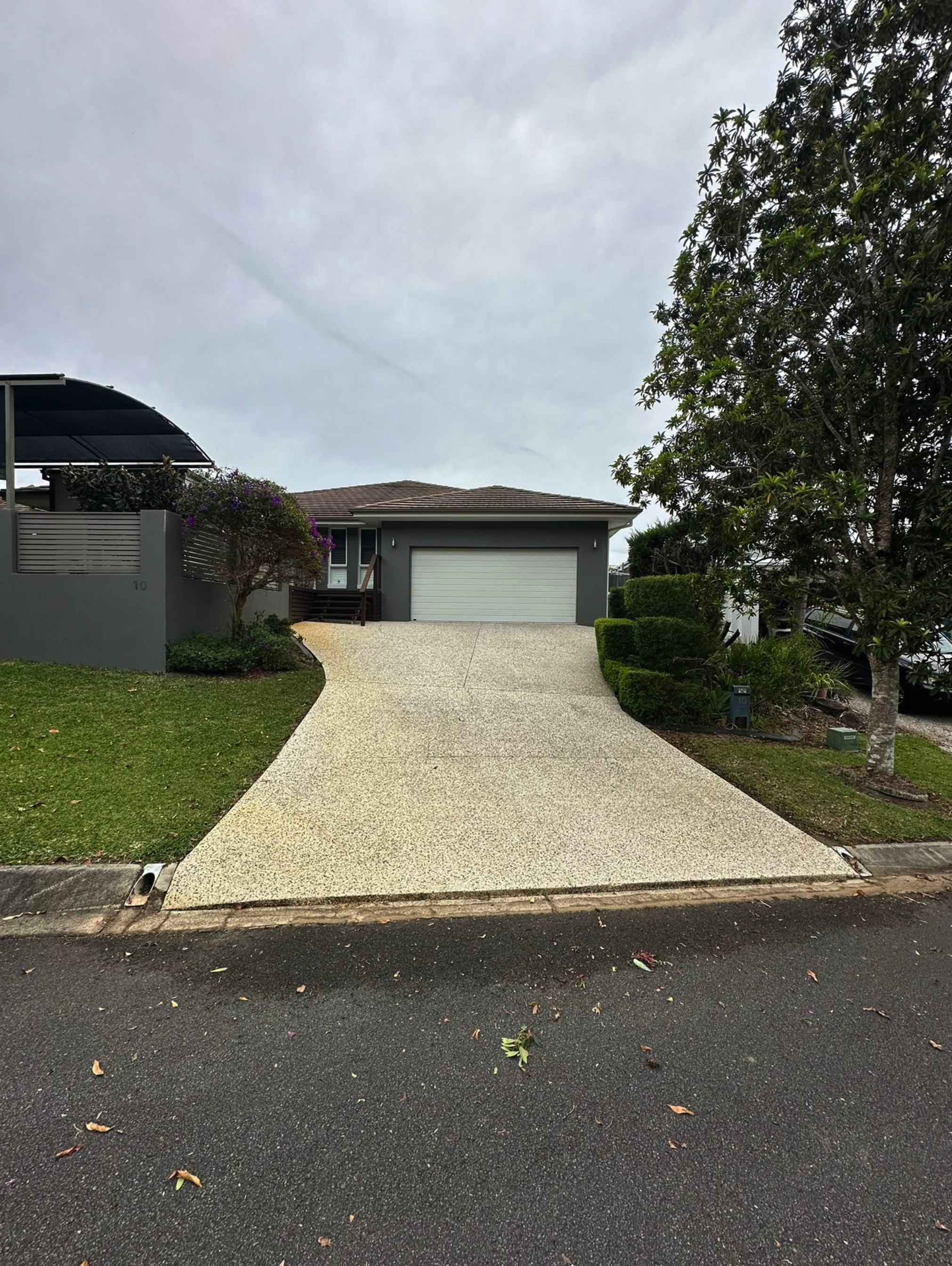 An exposed aggregate driveway after pressure washing, clean and even in colour