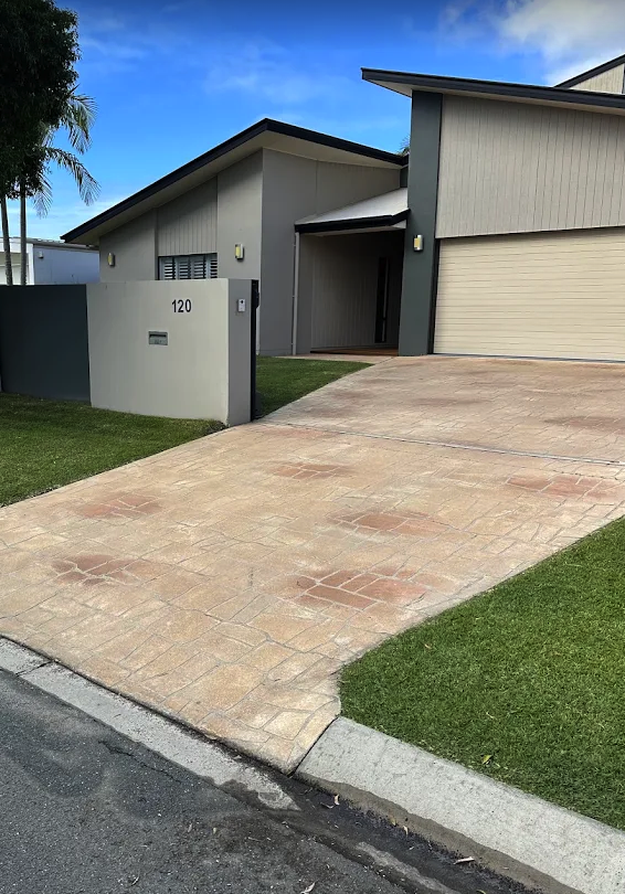A stamped concrete driveway cleaned to an even finish, right up to the lawn edge